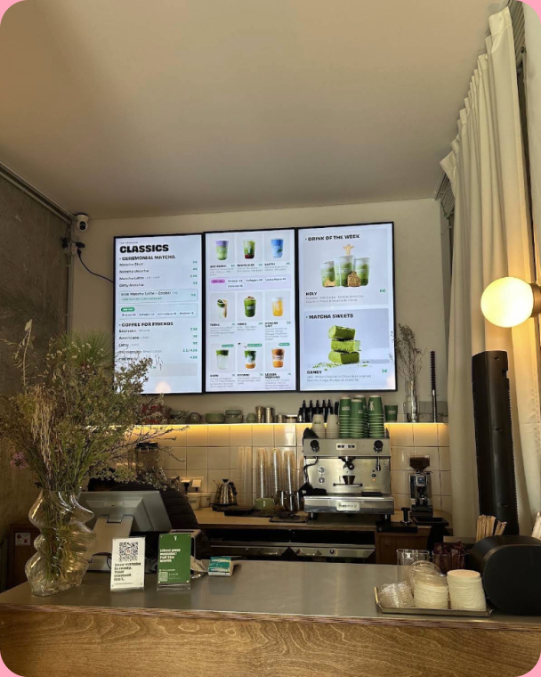 Inside the café: menu screens above the counter