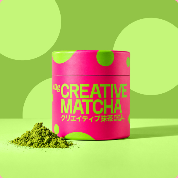 Creative Matcha jar with a heap of ceremonial matcha powder on a green backdrop